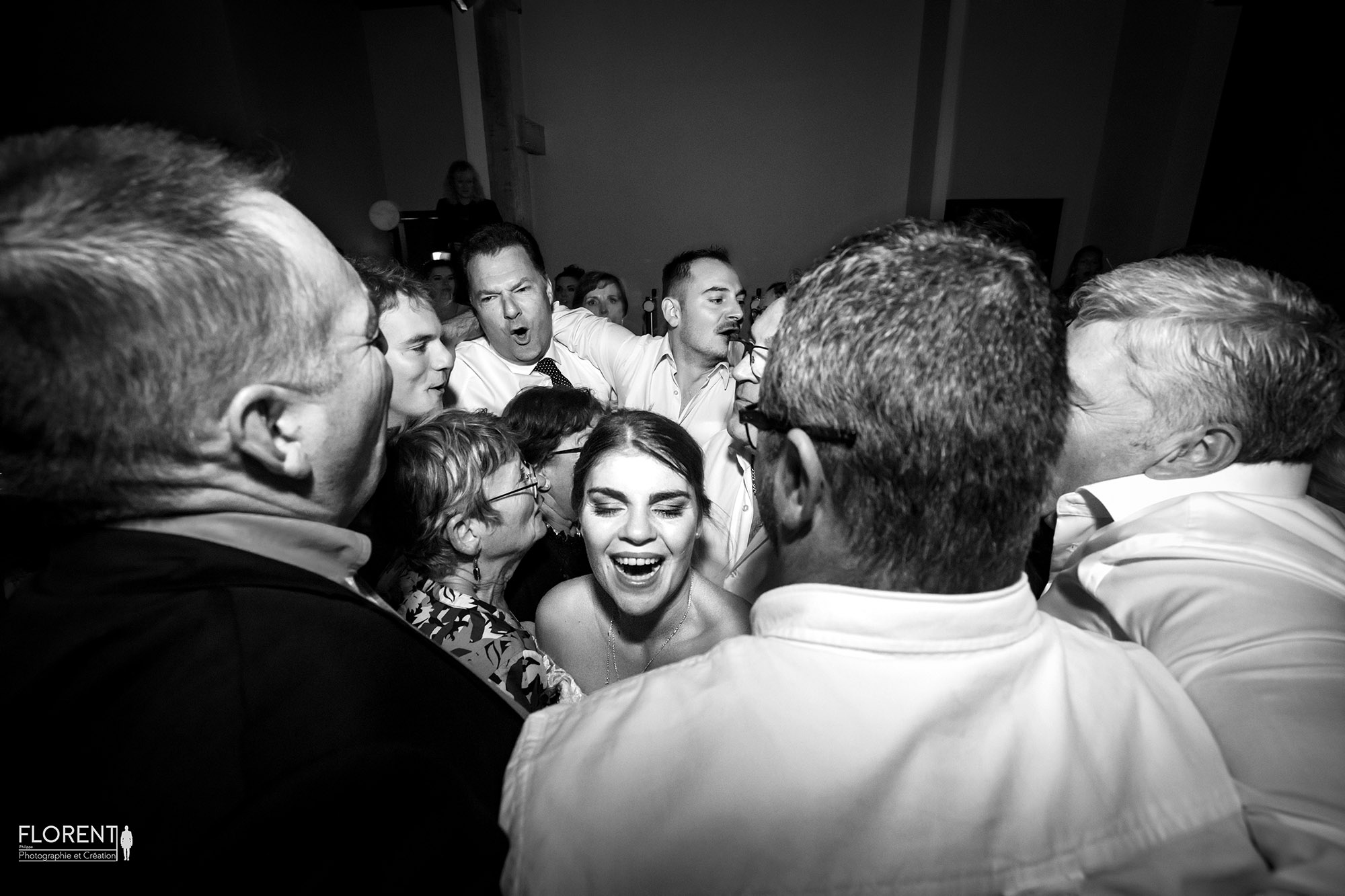 éclat de rire de la mariée serrée par ses témoins en noir et blanc